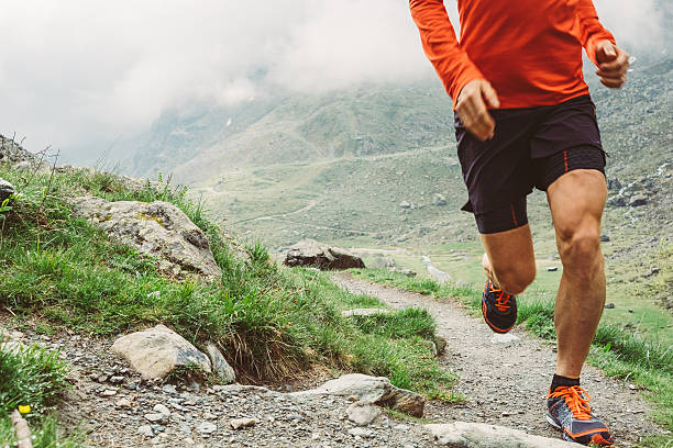 A man running on a trail path early in the morning